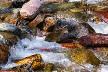 Water rushing over colorful rocks

