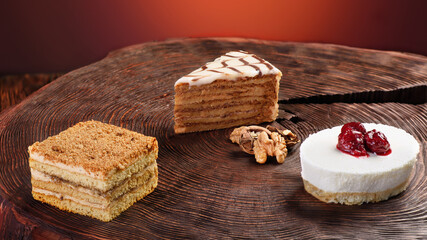 Dessert menu. Three different cakes on a wooden background. Photo for a banner. Space for text. High quality photo