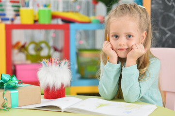 Close up portrait of cute smiling girl drawing