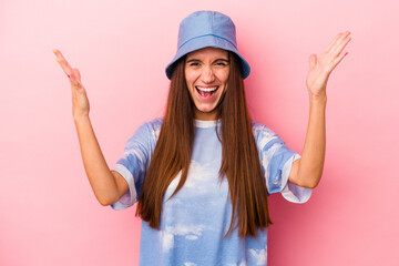 Young caucasian woman isolated on pink background receiving a pleasant surprise, excited and...