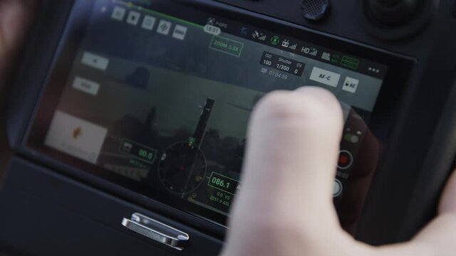 preparing a big drone RTK for flying over a roof to measure its size, changing Batteries, unfold the wings, camera 