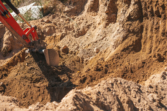 Excavator shovel digging on dirt