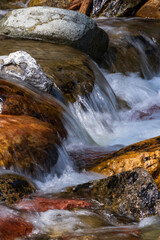 Water rushing over colorful rocks
