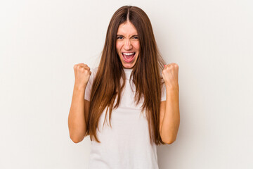 Young caucasian woman isolated on white background upset screaming with tense hands.