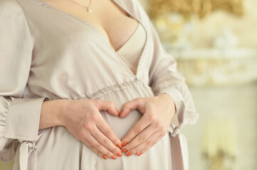 Obraz na płótnie Canvas Close up portrait of beautiful pregnant woman