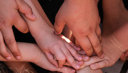 Children's hands piled on top of each other