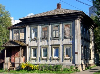 An old wooden residential house in the outback of Russia