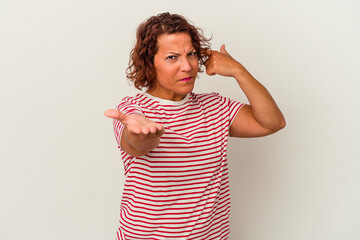 Middle age latin woman isolated on white background holding and showing a product on hand.