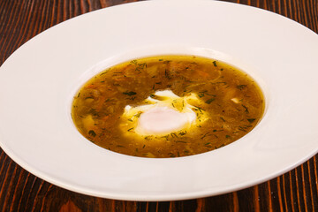 Chicken soup with poached egg