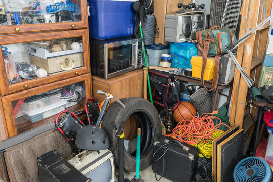 Storage clutter and household junk filling garage corner.  