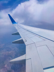 Obraz premium View from an airplane on a blue sky and white clouds.