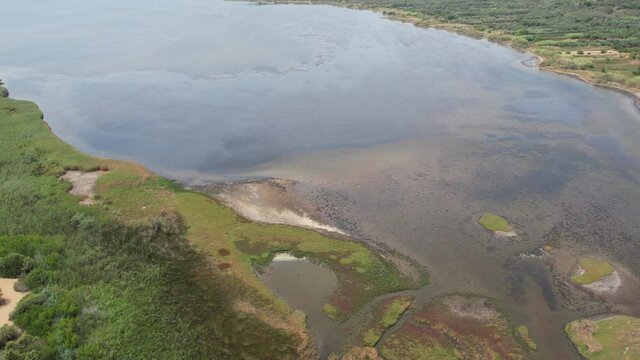 Aerial drone video over Lake Korission. Korission Lagoon is a coastal lagoon located in the southern part of Greek island of Corfu, in the Ionian Sea. It is separated from the sea by Chalikouna Beach.