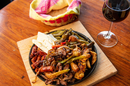 Authentic Mexican barbecue, different cuts roasted on a restaurant table. Chistorra, meat and grilled cheeses. Mexican roast beef concept