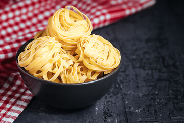 Different kind of raw pasta in bowls