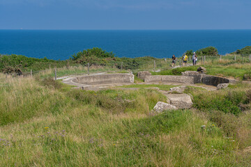 Fototapeta premium Pointe-Du-Hoc, France - 08 03 2021: Viewpoint from La Pointe-Du-Hoc. blockhouse building and Commemorative monument