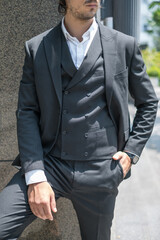 Fassion black suit on a young man. High quality photo