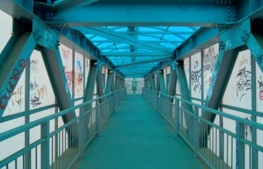A normal crossing in a provincial city of Russia. Aboveground pedestrian crosswalk with graffiti