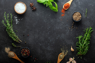 Obraz na płótnie Canvas Fresh herbs, spices on a black background, culinary concept, place for text.