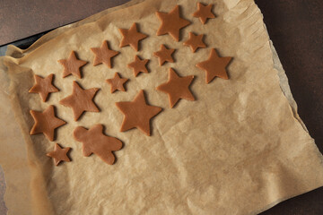 Christmas gingerbread dough in the cooking process. on a dark background