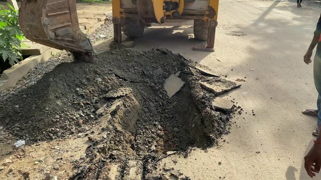 The modern excavator JCB performs excavation work on the construction site, JCB working on road construction