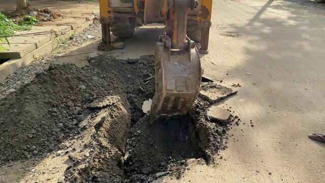 The modern excavator JCB performs excavation work on the construction site, 