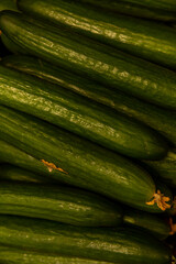 Long fresh cucumbers. Vitamins and healthy food. Vertical.