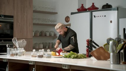 Cooking TV show celebrity host cooking a dish, talking into camera
