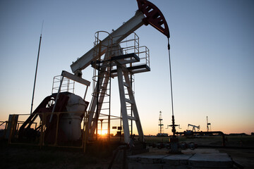 Oil Pump on orange sunset.