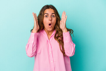 Young caucasian woman isolated on blue background  surprised and shocked.