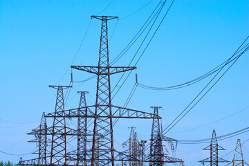 Power lines. High voltage towers against the blue sky.