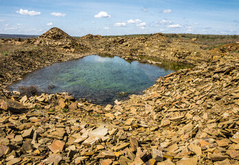 Small lake with clear water among yellow stones