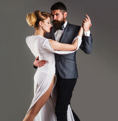 Beautiful couple in love dancing tango with passion. Professional dancers in ballroom.