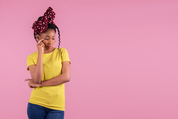 Afro american woman with polka dot ribbon lost in thought