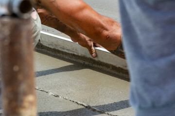 Worker Spreading Building Screed on a Floor of a House during Energy Redevelopment Work