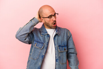 Fototapeta premium Young caucasian bald man isolated on pink background being shocked, she has remembered important meeting.