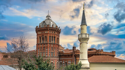 Fototapeta na wymiar Istanbul, Turkey - March 2018: Exterior view of the Phanar Greek Orthodox College, Ozel Fener Rum Lisesi, Fener neighborhood in Fatih district with a minaret of a nearby mosque