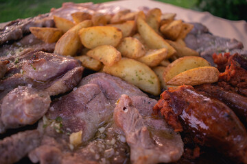 Grilled meat in a garden during a sunset