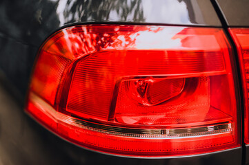 Taillight, headlight of a car of red color close-up.