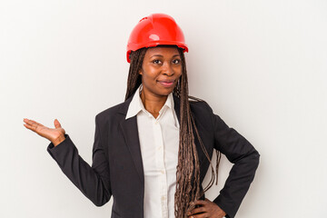 Young african american architect woman isolated on white background showing a copy space on a palm and holding another hand on waist.