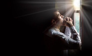 Praying man at the window