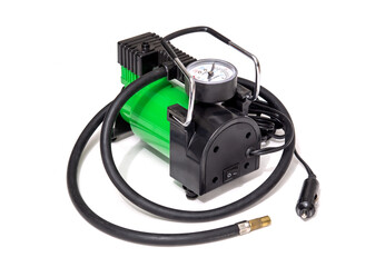 Car pump with manometer, green air compressor on white background. Inflating the wheels with air in the car.