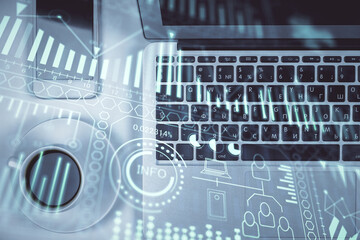 Technology hologram drawing over computer on the desktop background. Top view. Double exposure. Tech concept.