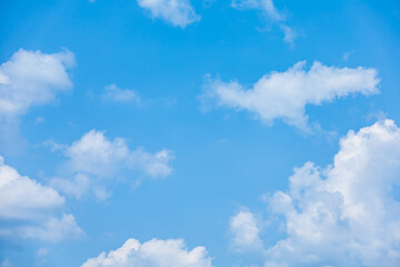 Naklejka na ściany i meble Blue sky with fluffy cumulus clouds floating in summer day. Pure white soft cloudscape scene, beautiful abstract in the air. Cloudy space view background. Tranquil environment, nature outdoor.