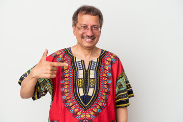 Obraz premium Senior indian man wearing a Indian costume isolated on white background person pointing by hand to a shirt copy space, proud and confident