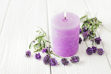 aromatherapy lavender candles and flowers on white wooden background
