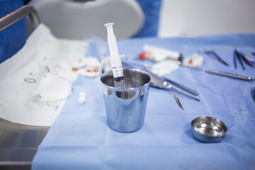 Medical tray table with dental tools and equipment during teeth surgery.
