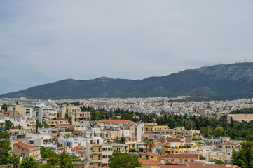 Fototapeta na wymiar Cityscape of Athens at cloudy day. City near mountain. Urban architecture in Europe. View from top.