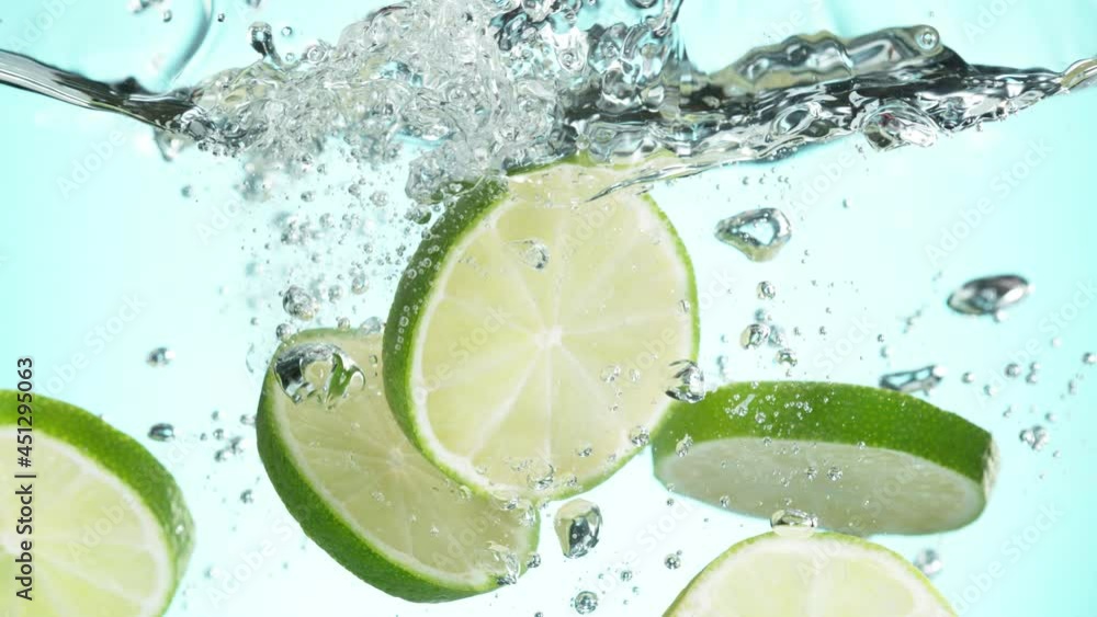 Aufkleber super slow motion of falling lime slices into splashing water. speed ramp effect. filmed on high spe