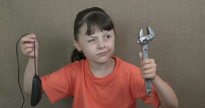 Young child with tools. A young little girl with a tool and a notebook mouse in the room.