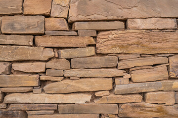 Background image of an ancient stone wall on the ruins of an old home in Utah.